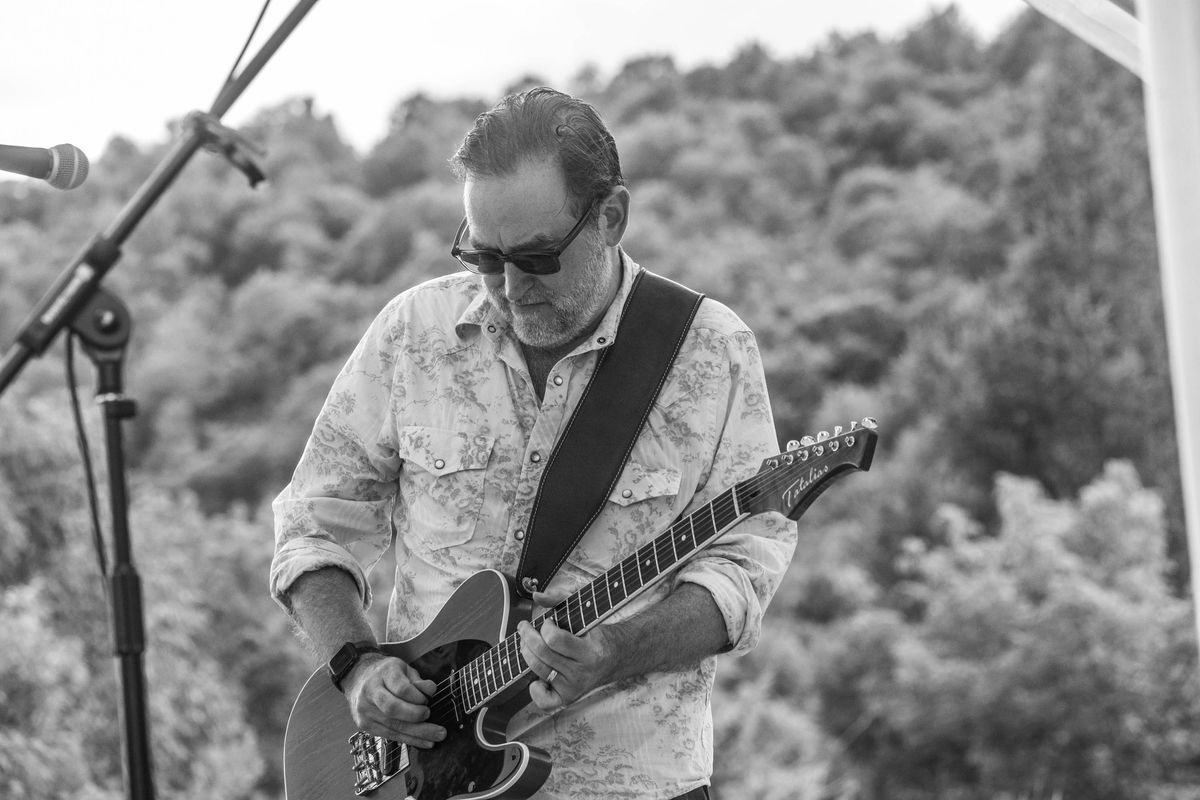 Brent Pruner playing guitar on stage