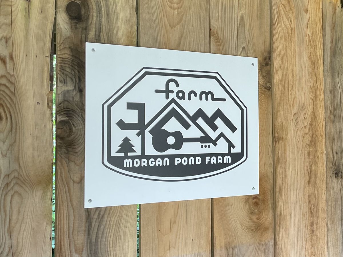 Farm Jam sign mounted on a wood fence